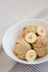 Homemade Peanut Butter Banana Ice Cream in a Bowl, side view. Copy space.