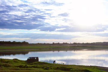 Fototapeta premium Fishing in the morning with sunrise . lakeside scenery 