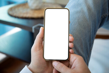 male hand holding gold phone with isolated screen jeans background