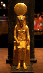 Religion of Ancient Egypt. Sekhmet - Goddess of the scorching sun, war and healing. Ancient Egyptian goddess with the head of a lioness. Gold statue