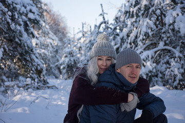 happy couple in the snowy forest