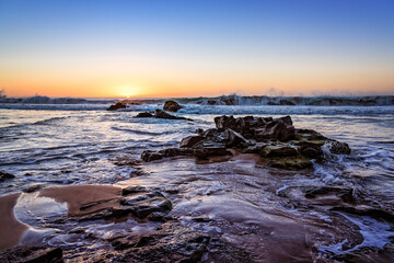 Scenic view of sandy beach with rocks against sky during sunset. El Cotillo, Fuerteventura, Canary Islands. Holidays concept