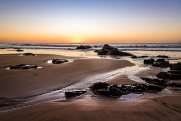 Scenic view of sandy beach with rocks against sky during sunset. El Cotillo, Fuerteventura, Canary Islands. Holidays concept