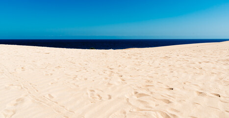 Fototapeta na wymiar Scenic view of dunes on the beach against sky. Corralejo, Fuerteventura, Canary Islands. Holidays concept