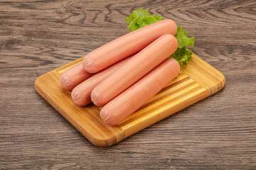 Tasty meat sausages over board