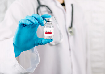 Doctor holding vaccine bottle coronavirus and medical in the hospital