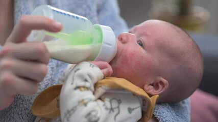 baby drinking milk from a bottle