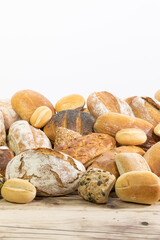 Many kinds and kinds of bread collected in one place on a wooden old shop counter as a decoration for a traditional bakery. White background from the top for self-completion.