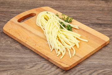 Chechil spaghetti cheese over board