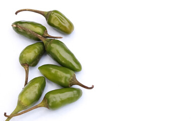 Green chillies on white background