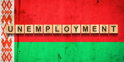 Obraz premium Unemployment. The inscription on wooden blocks on the background of the Belarus flag. Unemployment growth. Business.