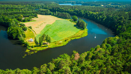 Alone white boat on a winding river in summer, Poland