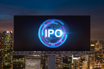 IPO icon hologram on road billboard over night panorama city view of Singapore. The hub of initial...