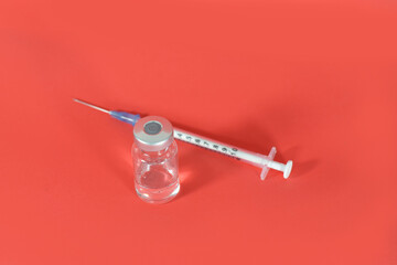 A Vial and A syringe Isolated with Red Background