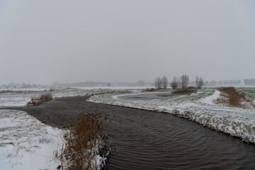 Creek in winter landscape with snow