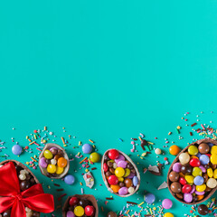Obraz na płótnie Canvas Festive Easter background with chocolate eggs and sweets