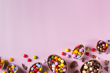 Fototapeta na wymiar Festive Easter background with chocolate eggs and sweets