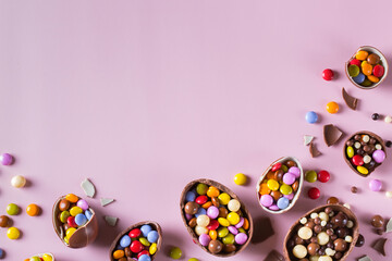 Fototapeta na wymiar Festive Easter background with chocolate eggs and sweets