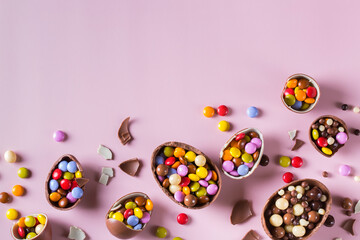 Fototapeta premium Festive Easter background with chocolate eggs and sweets