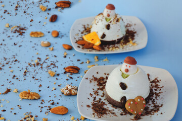 Ice cream background in the shape of two edible snowmen on white plates close up. Top view. Creative idea for Christmas and New Year festive desserts. Funny food idea for kids.