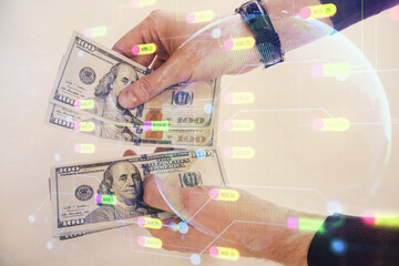 Multi exposure of technology drawing hologram and us dollars bills and man hands. Data concept