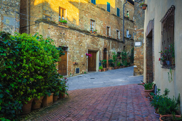 Wonderful street and entrances decorated with colorful flowers, Tuscany, Italy