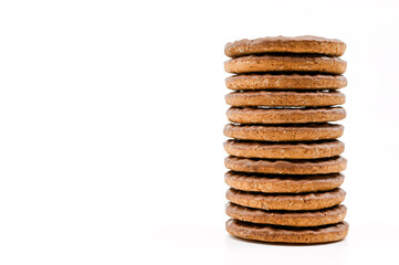 Stack of chocolate covered biscuits against a plain white background. No people. Copy space.