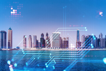 Naklejka na ściany i meble Skyscrapers of Dubai business downtown. International hub of trading and financial services. Technology theme icons hologram, Fintech concept. Double exposure. Dubai Canal waterfront.