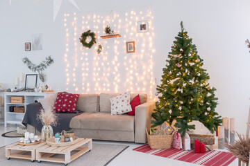 large very bright spacious stylish open plan Bali style apartment with hanging bed and panoramic windows. white floor and walls, simple wooden furniture. decorated with a christmas tree