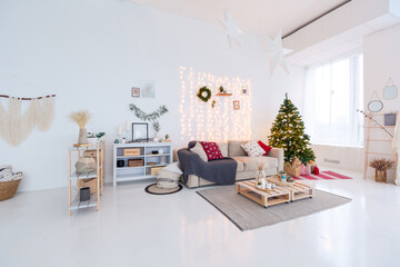 large very bright spacious stylish open plan Bali style apartment with hanging bed and panoramic windows. white floor and walls, simple wooden furniture. decorated with a christmas tree