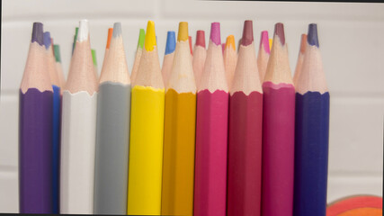 A set of colored pencils, stationery. A lot of multicolored pencils on the table.