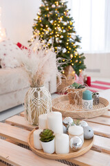 large very bright spacious stylish open plan Bali style apartment with hanging bed and panoramic windows. white floor and walls, simple wooden furniture. decorated with a christmas tree