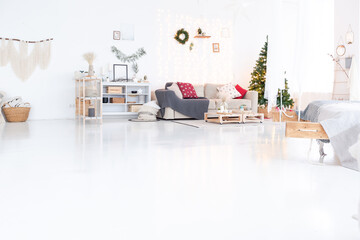 large very bright spacious stylish open plan Bali style apartment with hanging bed and panoramic windows. white floor and walls, simple wooden furniture. decorated with a christmas tree