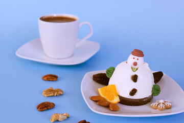Ice cream in the shape of edible snowman on white plate and coffee cup close up. Top view. Creative idea for Christmas and New Year festive desserts. Funny food idea for kids.