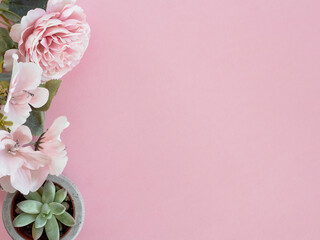 Pink flowers on one side of pink background. Flower background. Space for text