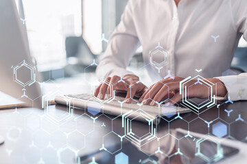 Woman typing the keyboard to create innovative software to change the world and provide a completely new service. Close up shot. Hologram tech graphs. Concept of Dev team. Formal wear.