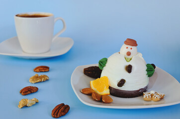Ice cream in the shape of edible snowman on white plate and coffee cup close up. Top view. Creative idea for Christmas and New Year festive desserts. Funny food idea for kids.