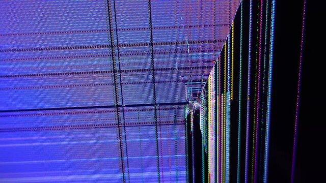 Malfunctioning shattered computer monitor. Abstract technology background. Flickering video footage of bad LCD display. Close up on cracked TV screen.
