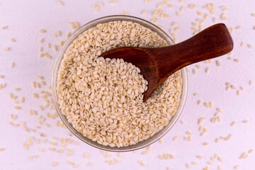 Sesame seeds in a plate on a white background. Flat lay.
