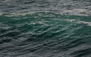 A glassy wave about to crash