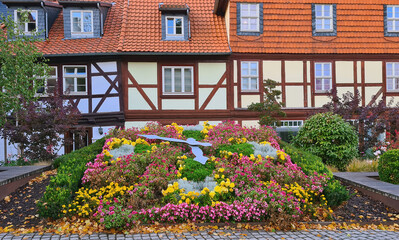 Flower clock in a front of timbered house in an old European town