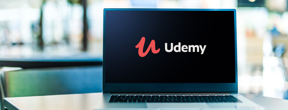 Laptop computer displaying logo of Udemy
