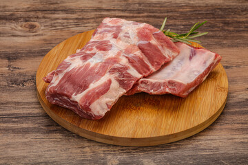 Raw pork ribs served rosemary