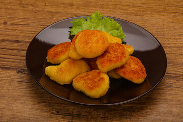 Fried chicken nuggets served salad leaves