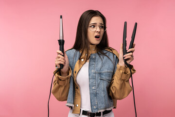 Photo of attractive lady holds broken curling hair disappointed and amazed, wears casual jeans jacket white undershirt isolated pink color background.