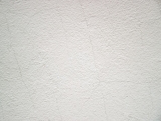 White background with grain and roughness. Stock photo of thin cracks on a light surface.