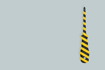 Fototapeta premium Metal screwdriver with a striped rubberized handle. Background on the theme of tools, service, repair. 
