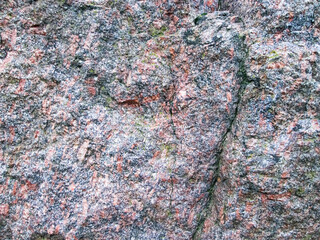 The texture of granite rough stone. Old, hard surface with roughness.