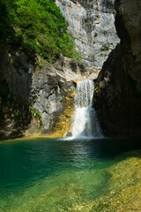 Fototapeta na wymiar Majestic Hidden Waterfall in Natural Landscape, located in the Aragonese Pyrenees, Huesca, Spain.