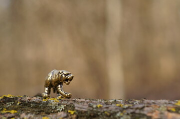 A metal tiger figurine on a dark background.